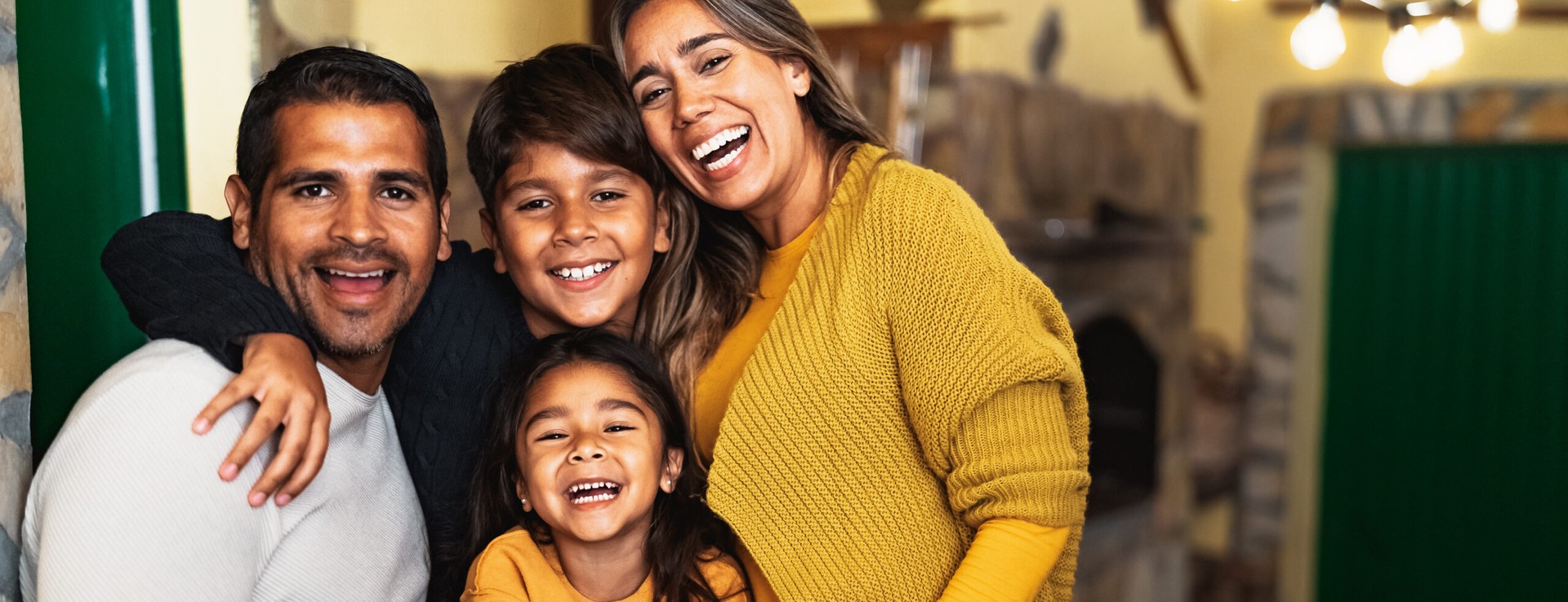 Happy Hispanic family enjoying holidays together at home