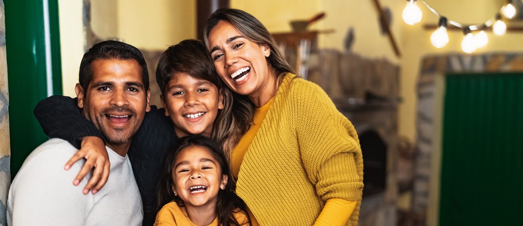 Happy Hispanic family enjoying holidays together at home